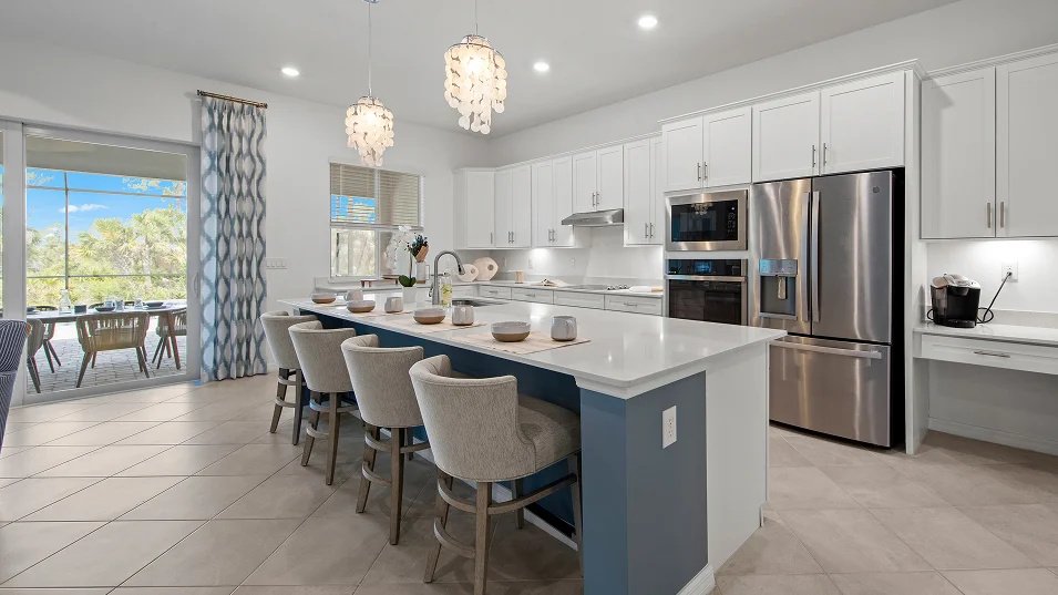 Kitchen with a blue island and sliding doors to the screened lanai